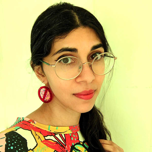 Woman wearing covid earrings