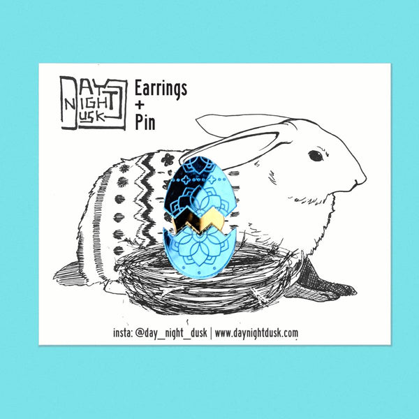 Spring jewellery featuring blue cracked Easter egg studs with a surprise golden pin