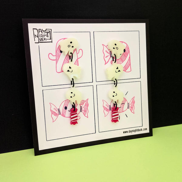 spooky ghost earrings on comic card with candy