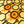 Load image into Gallery viewer, Statement earrings made from honey coloured laser cut acrylic featuring honeycomb, dripping honey and honey bee encased in black hexagon