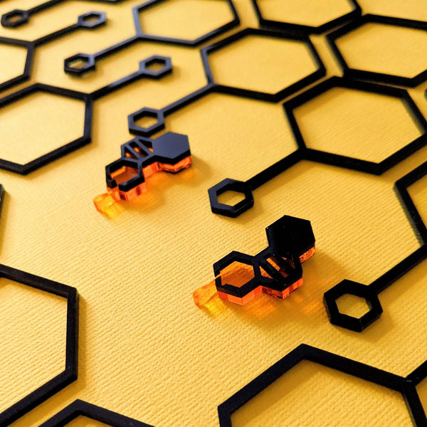 Orange and black honeycomb studs dripping with honey