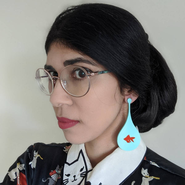 Modern statement earrings in a shape of a teal fishbowl with orange fish