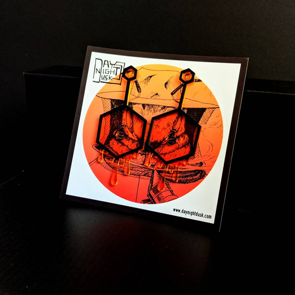 Fun earrings made from orange laser cut acrylic featuring queen bee inside a honeycomb, perfect gift for nature lovers