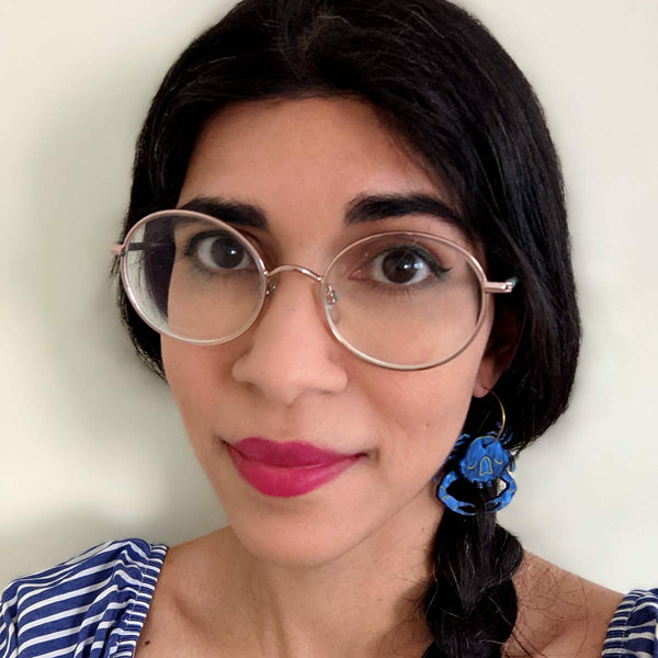 woman wearing blue swimmer crab acrylic hoop earrings