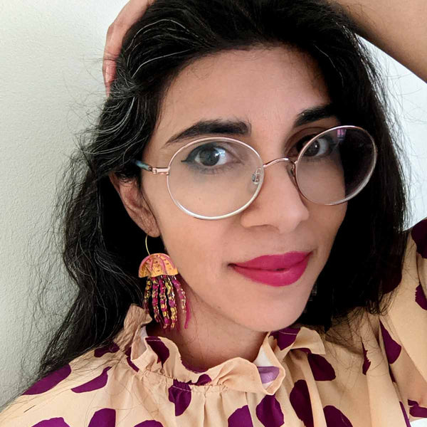 woman wearing pink jellyfish acrylic hoop earrings