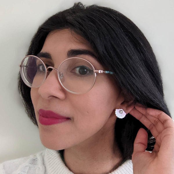 woman wearing blush pink pearl shell acrylic stud earrings