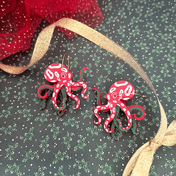 Peppermint coloured octopus on a festive christmas background