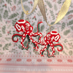 Quirky octopi hoop earrings on festive background