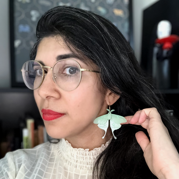 Woman wearing elegant moon moth butterfly wings earrings