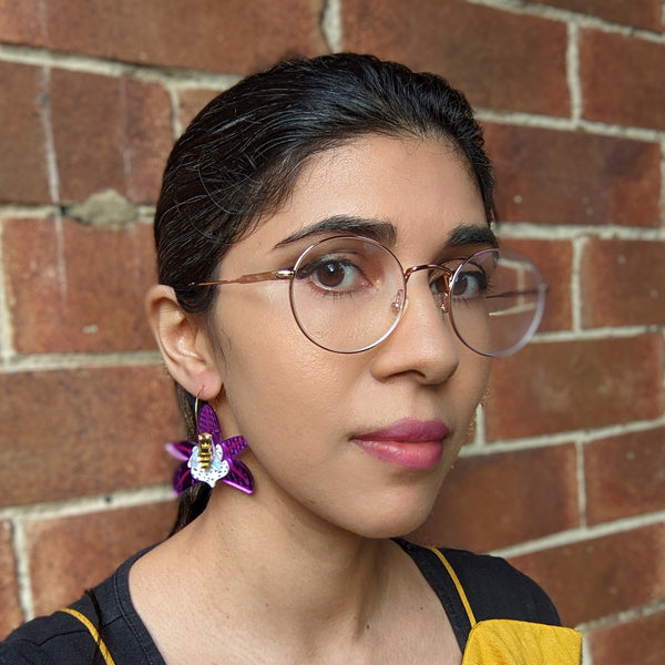 Woman wearing orchid earrings statement jewelry